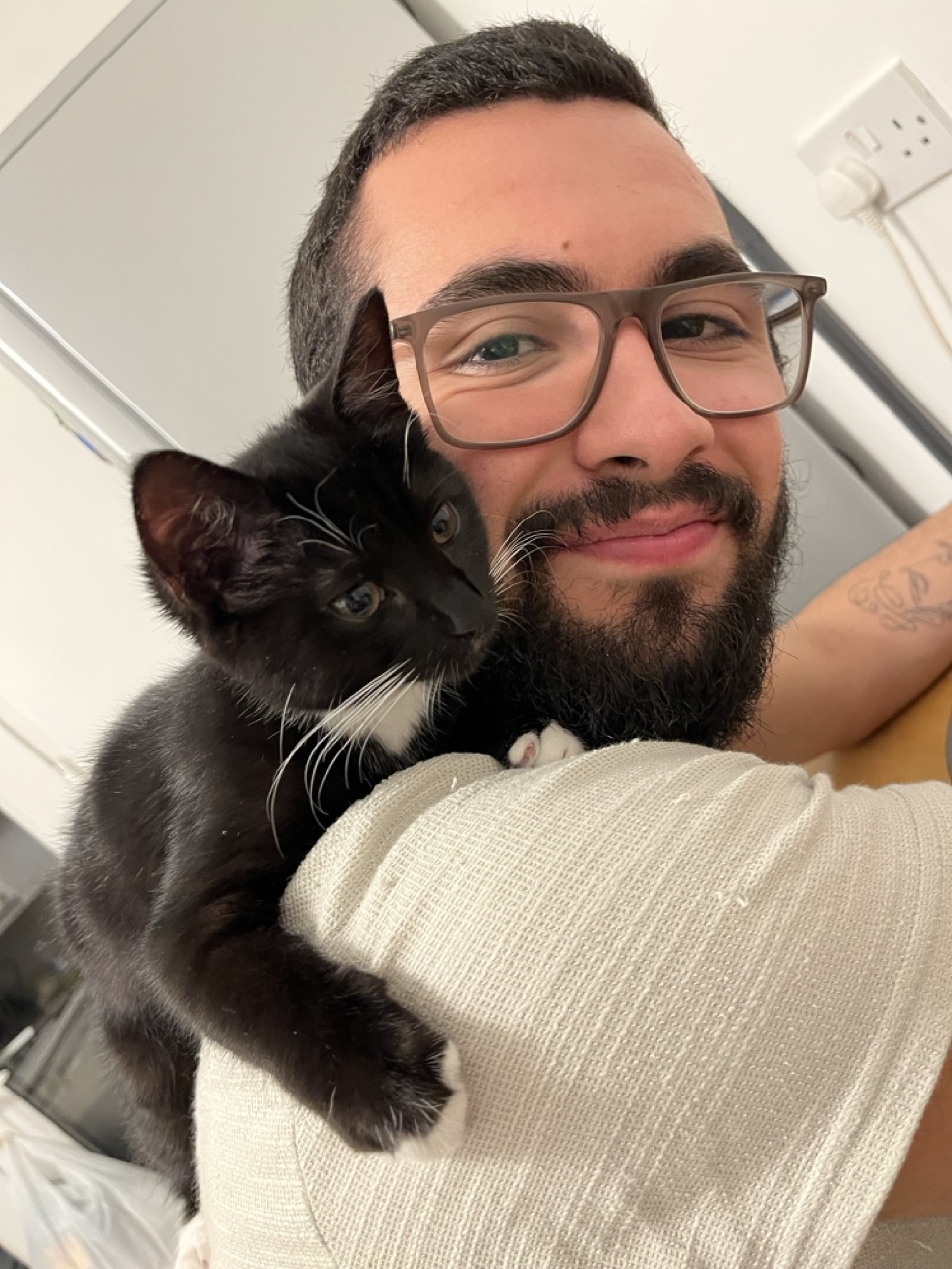 Sergio sitting with his kitten (at the time) in his old flat