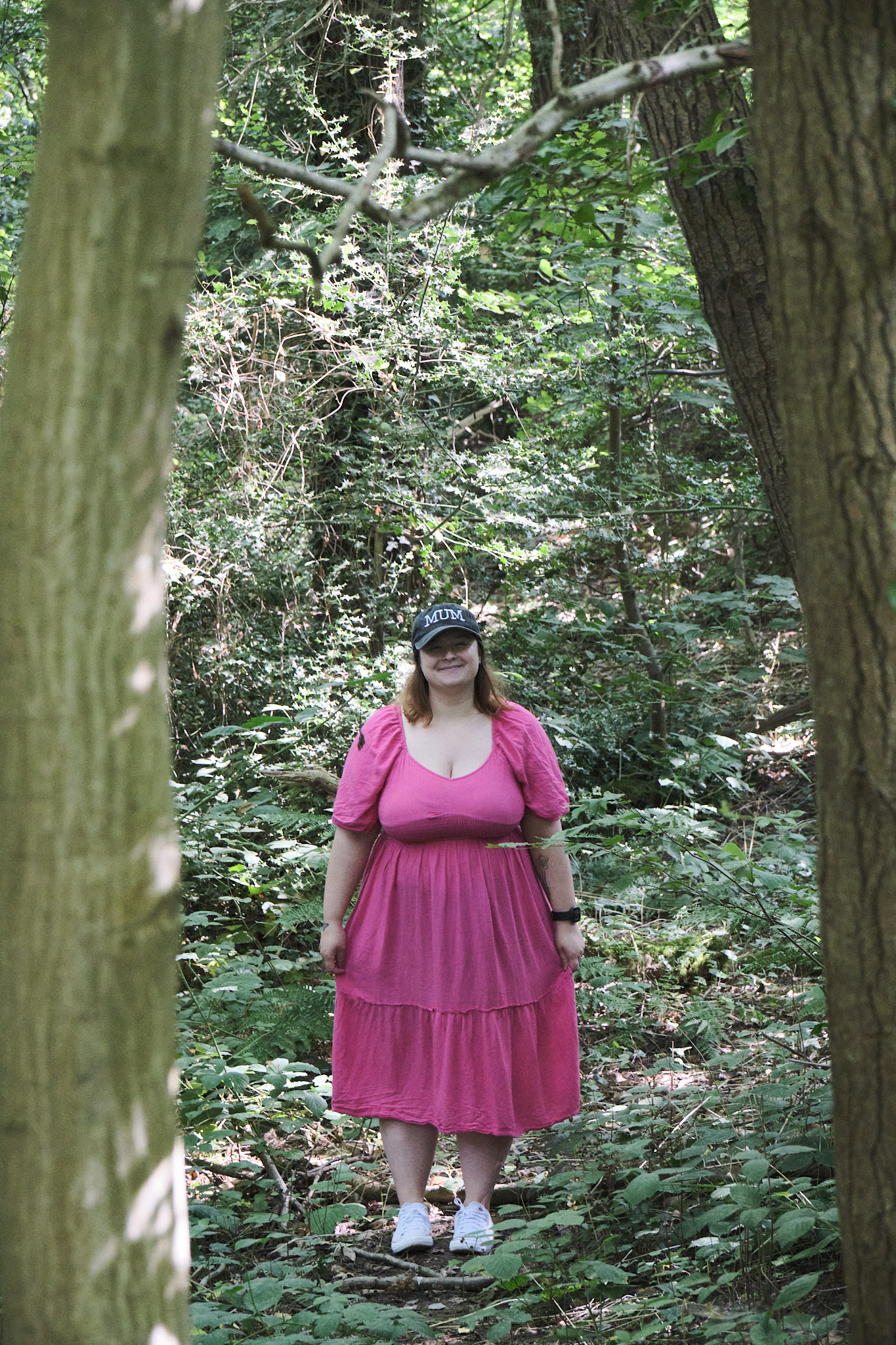 A portrait of my fiancé posing behind two connecting trees